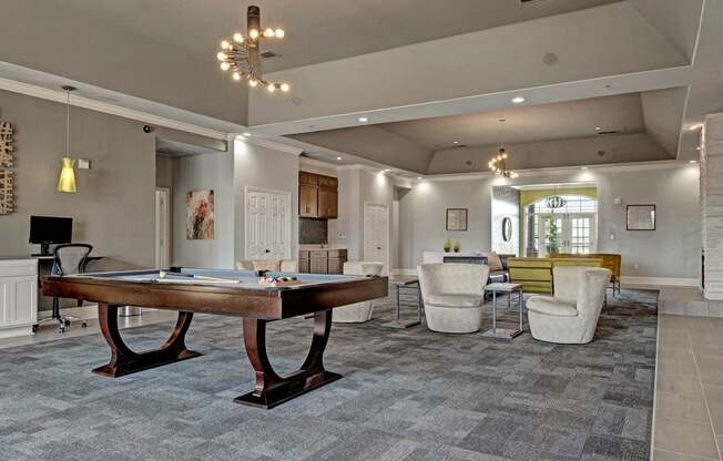 a games room with a shuffleboard table and couches