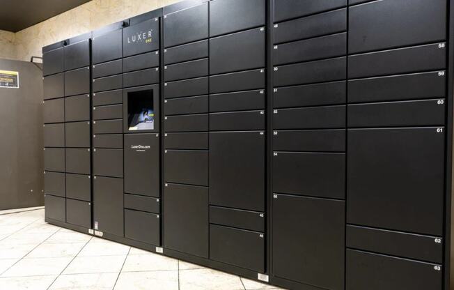 a row of black lockers in a building with a window