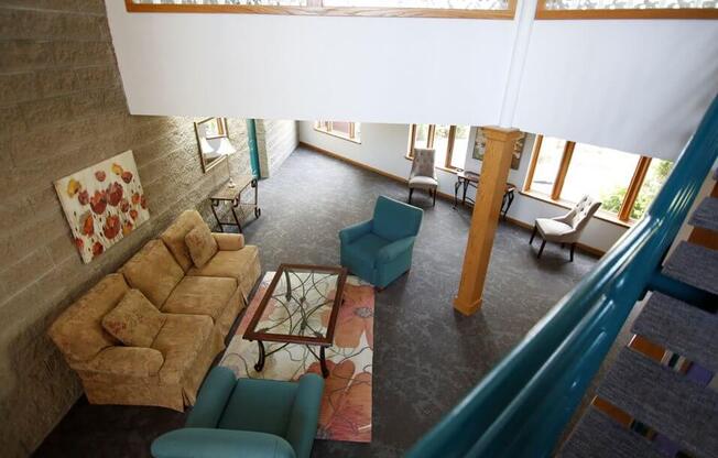 a living room with a couch chairs and a table