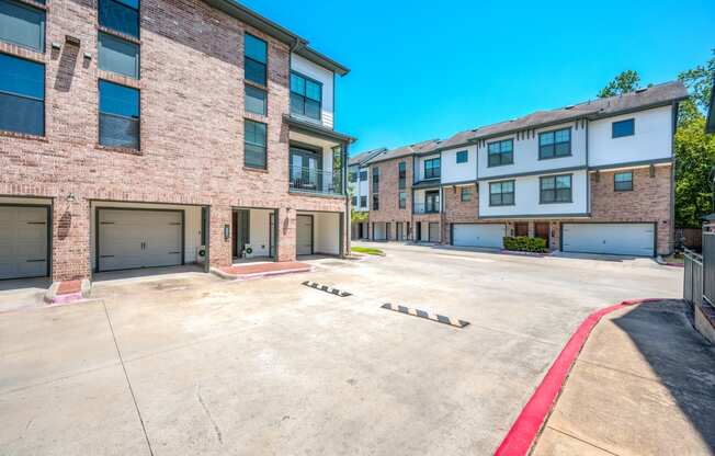 an empty parking lot in front of a brick building