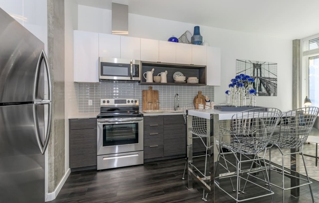 a kitchen with white cabinets and stainless steel appliances