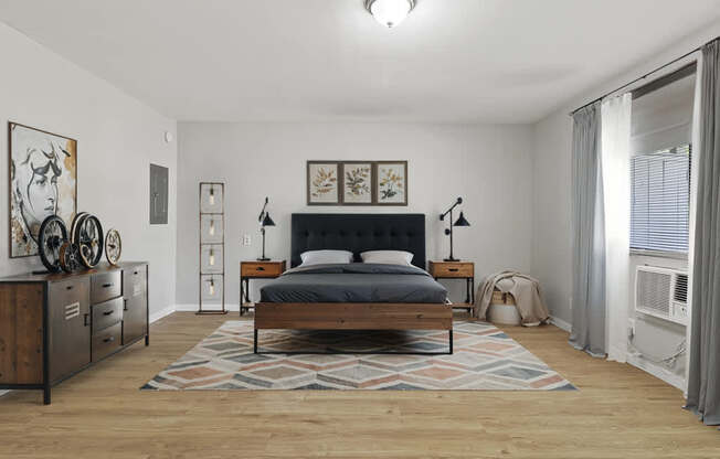 Element at 4411 Macon Apartments A bedroom with a bed, nightstands, and a rug.