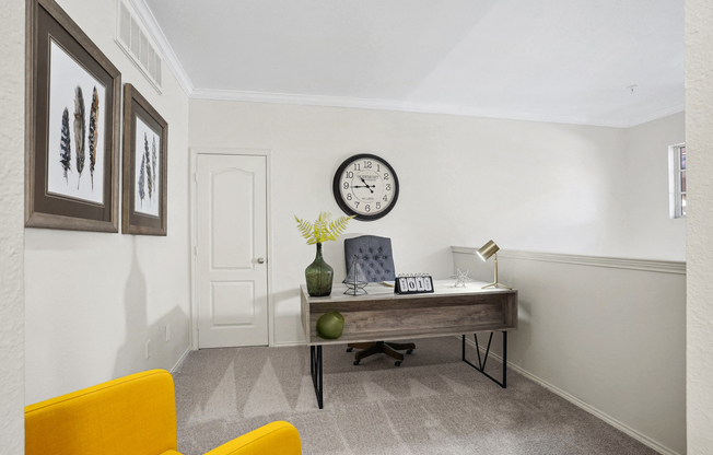 a home office with a desk and a clock on the wall at La Ventura Apartments, Plano, TX, 75093