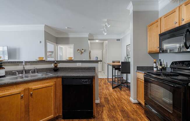 a kitchen with an island and a stove top oven and a sink