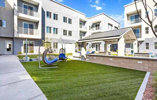 A modern apartment complex with a playground and a slide.