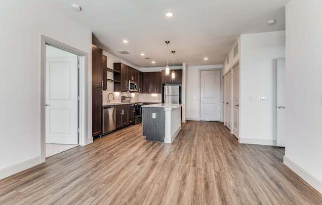 A kitchen with wooden floors and white walls.