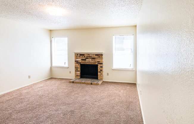 Living Room with Fireplace at Heritage Square Apartments in Waco, TX