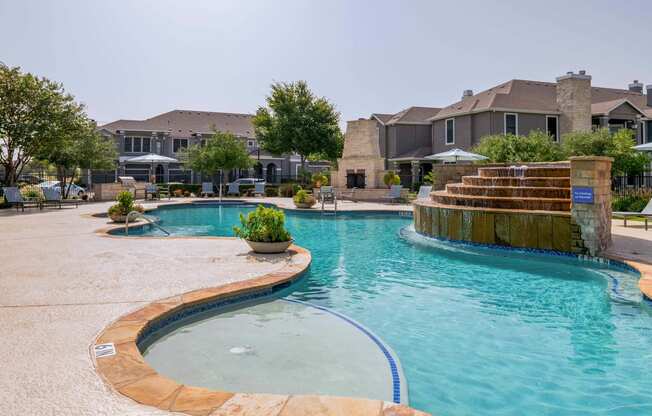 a large swimming pool with a house in the background