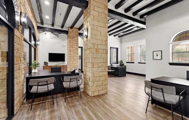 a dining room with a table and chairs and a brick wall