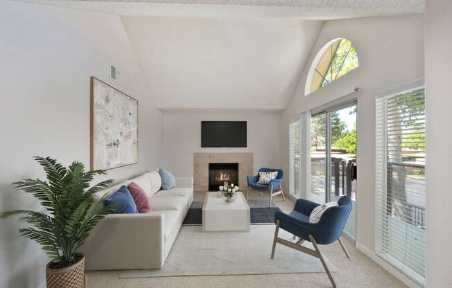 a living room with a couch and chairs and a fireplace