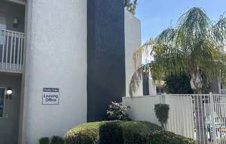 a building with a flower garden in front of it