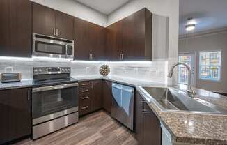 a modern kitchen with stainless steel appliances and granite counter tops