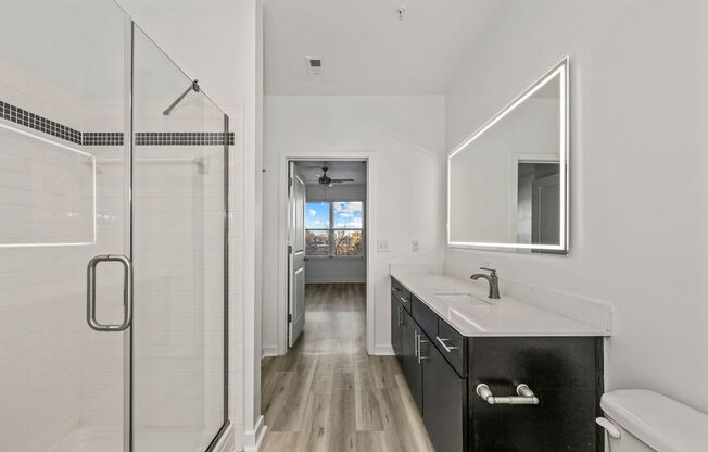 a white bathroom with a sink and a shower