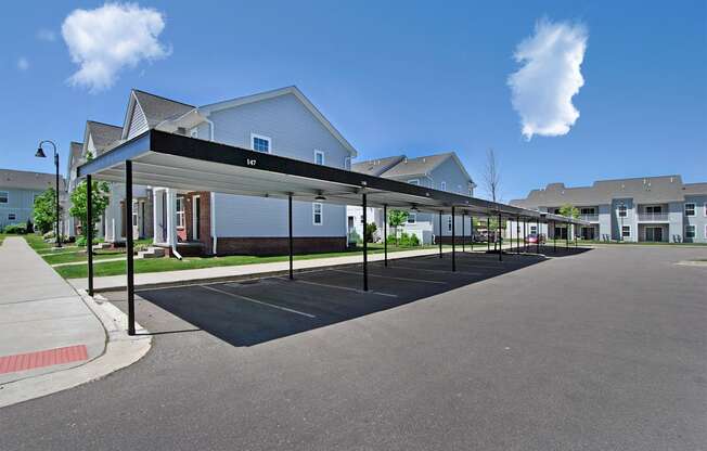 an empty parking lot in front of a row of houses