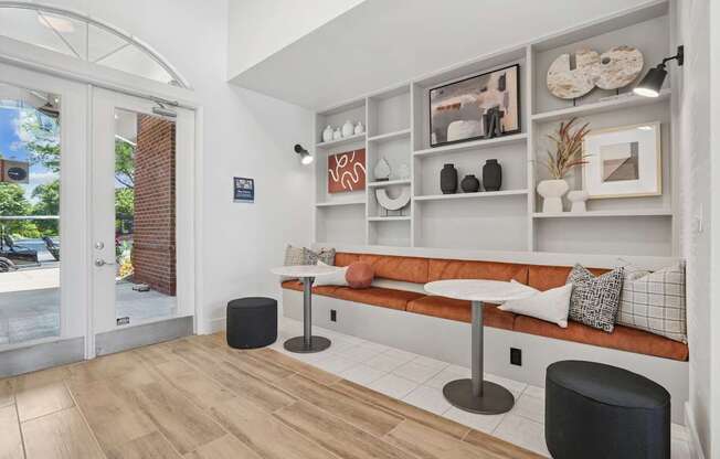 A modern living room with a white sofa and a wooden floor.