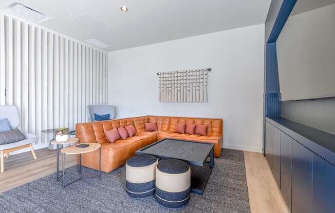 a living room with a brown leather couch and two blue chairs at Marina Square, Washington