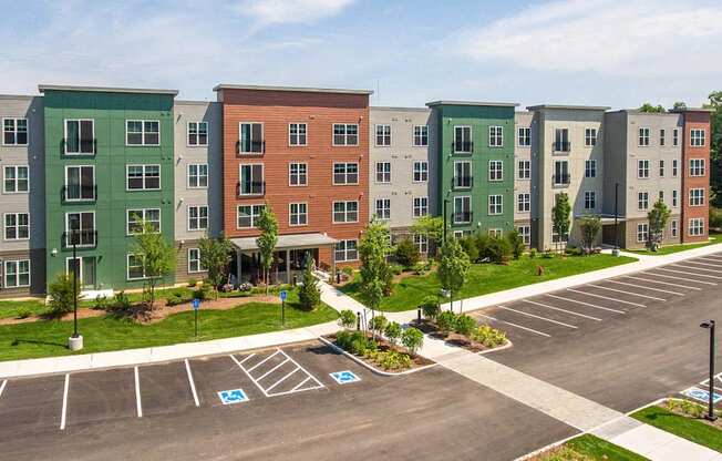 an aerial view of an apartment building in a parking lot