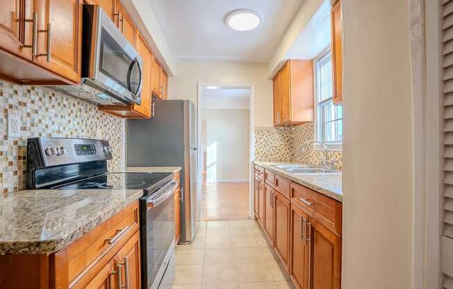 A kitchen with wooden cabinets and a tile backsplash Integrity Realty, Cleveland, OH