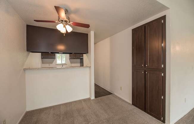 A room with a ceiling fan and a window with blinds at Pepperwood Apartments, California, 95661