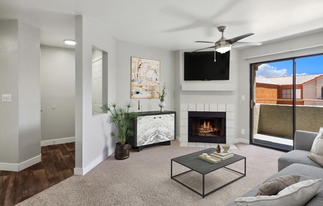 a living room with a fireplace and a flat screen tv