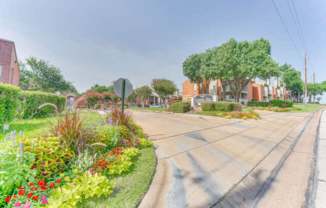 A street view with a stop sign and a building in the background at Copper Hill Apartments, Bedford, TX