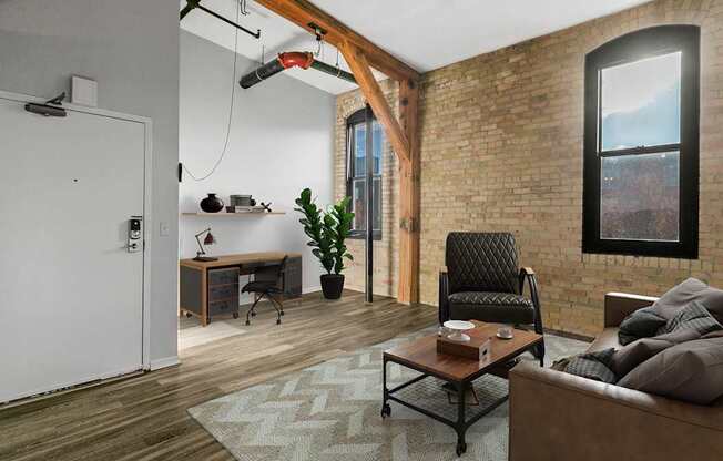 A modern living room with a brick wall and a large window.