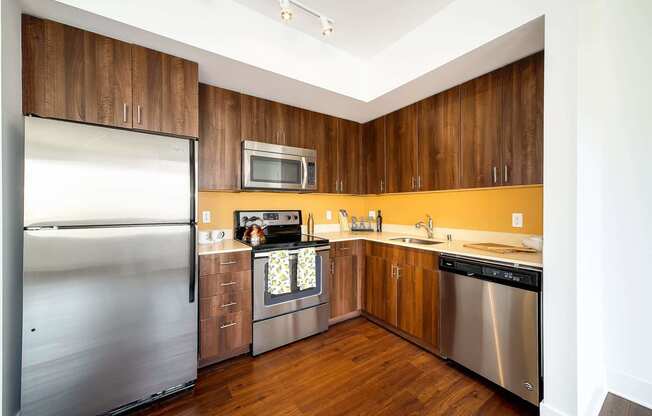 a kitchen with stainless steel appliances and wooden cabinets