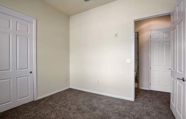 A room with carpeted floor and white walls.