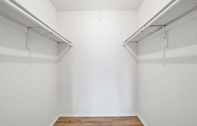 A room with white walls and a wooden floor.