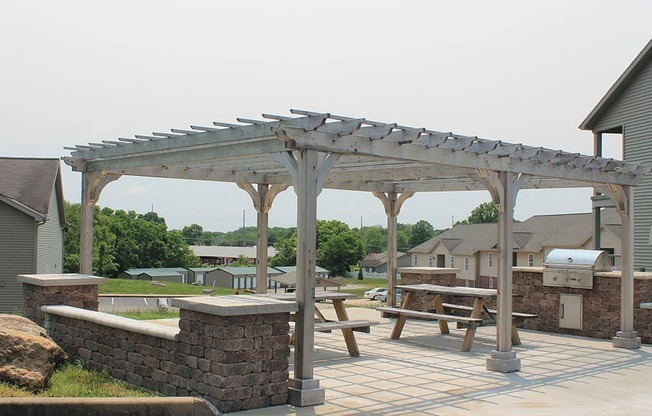 a pergola and picnic table on a patio