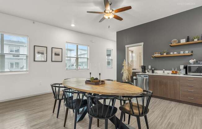A modern dining room with a round wooden table and chairs.
