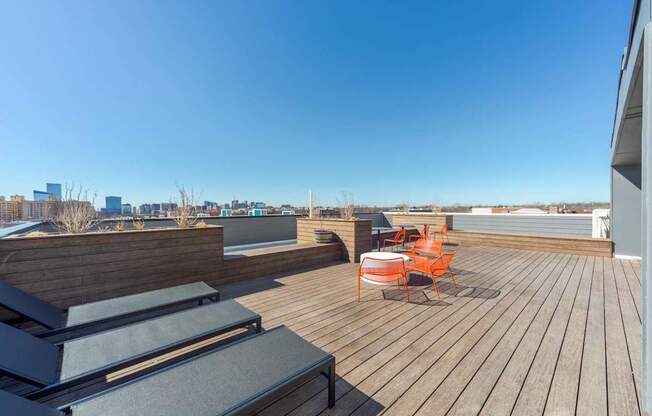 A wooden deck with two chairs and a table.