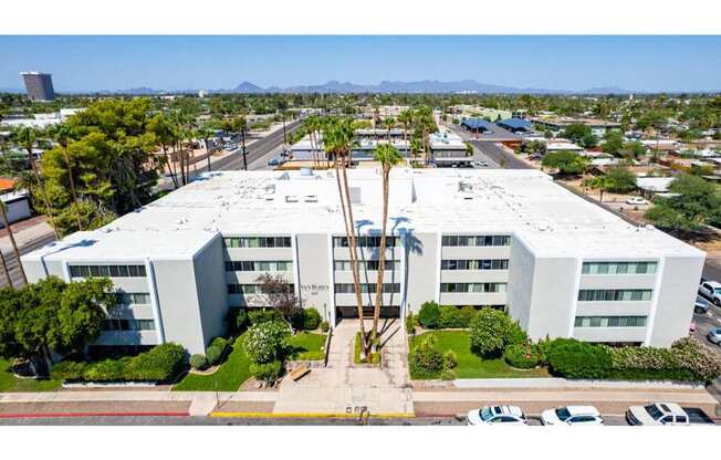 A large white building with a parking lot in front of it.