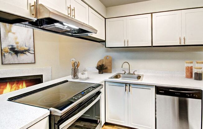 a kitchen with a stove top oven and a sink