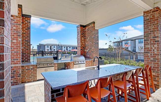 the kitchen has a large island with a granite counter top