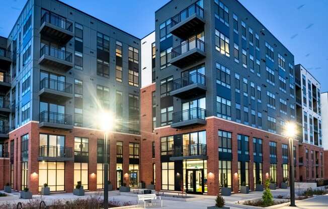 an exterior view of an apartment building at dusk