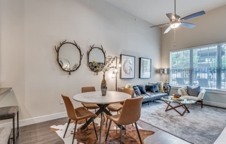 an open living room with a dining room table and a couch