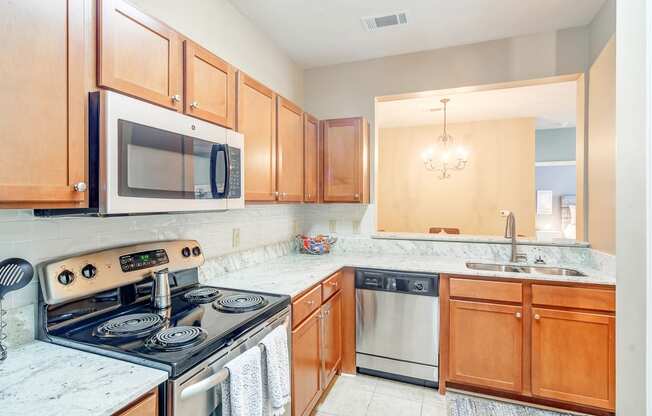 a kitchen with wood cabinets and a stove and a microwave