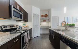 a kitchen with granite counter tops and stainless steel appliances