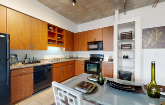 a kitchen with wooden cabinets and a glass table
