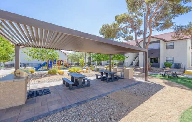 a park with picnic tables and a playground