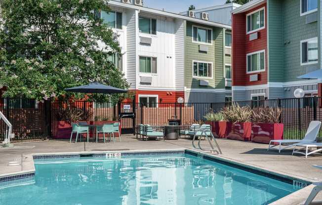 our apartments have a pool and a patio with chairs and tables