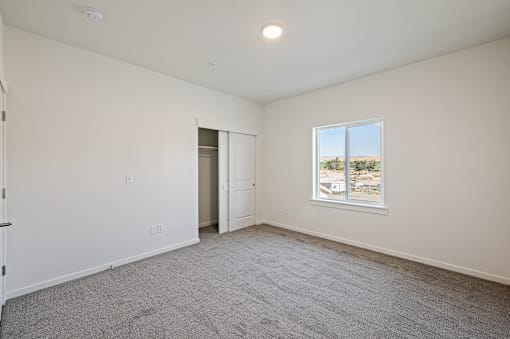 an empty living room with white walls and a window at Gateway Apartments, East Wenatchee , WA