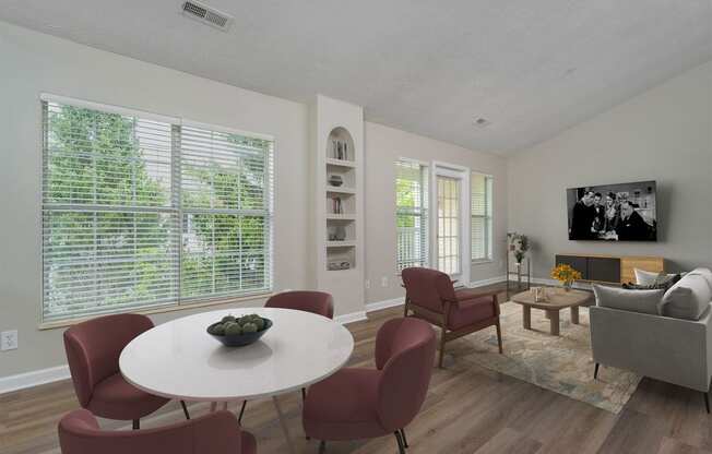 a living room with a table and chairs and a television