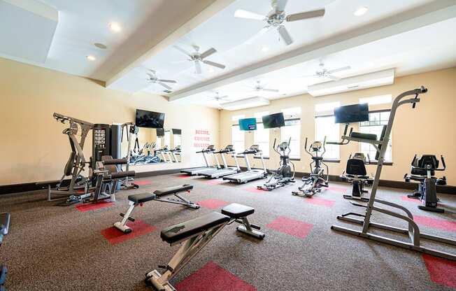 a gym with weights and other exercise equipment in a large room