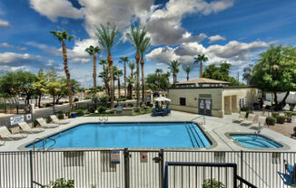 a swimming pool at a resort with palm trees at Villas on Bell, Phoenix, 85053