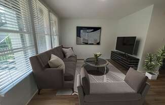 a small living room with a couch and two chairs at The Courts Midtown, Memphis, TN, 38104
