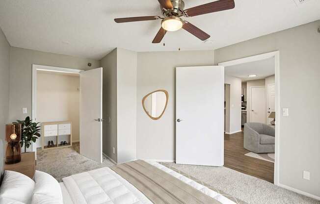 A living room with a white couch and a ceiling fan.