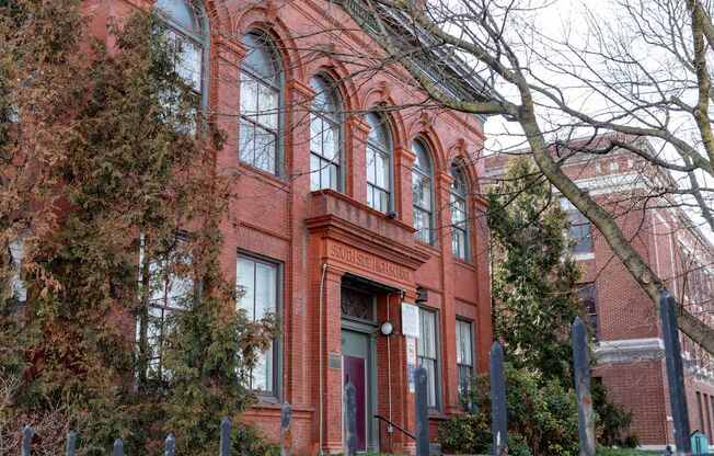 a red brick building with trees in front of it