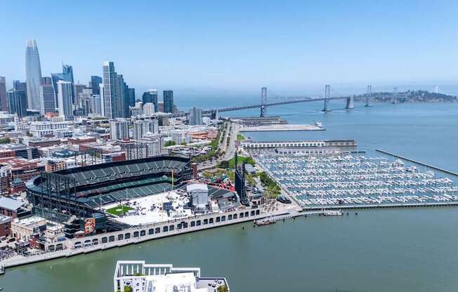 A cityscape with a large body of water and a bridge in the background.
